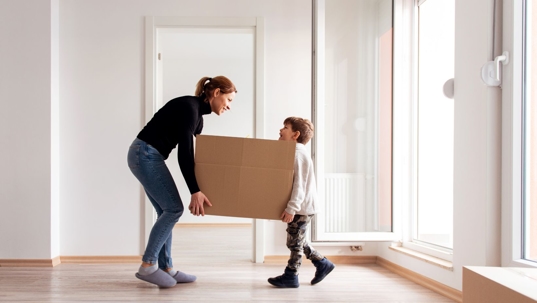 mom and son moving boxes