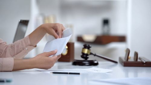 woman putting case into an envelope at a lawyers office