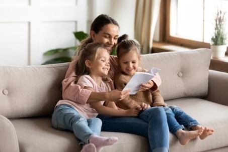 mother and daughters reading