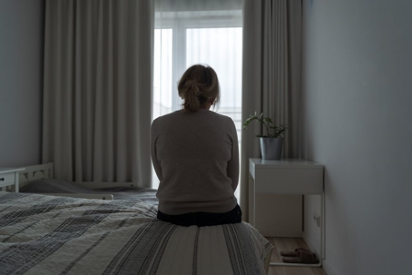 mature woman sitting alone room sad