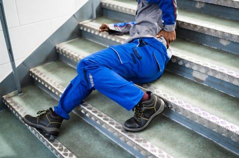 injured man laying on steps after slipping and falling