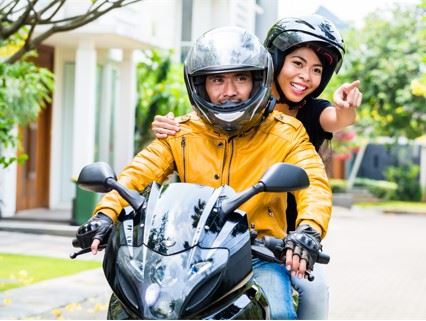 man and woman riding double on a motorcycle