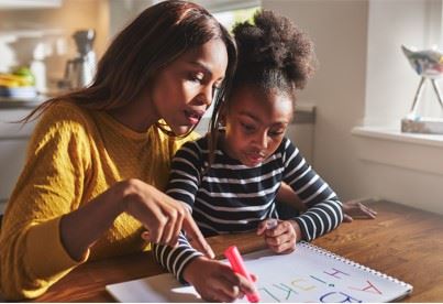 mother and daughter doing schoolwork